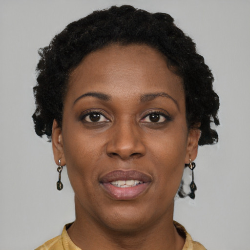 Joyful black young-adult female with short  brown hair and brown eyes