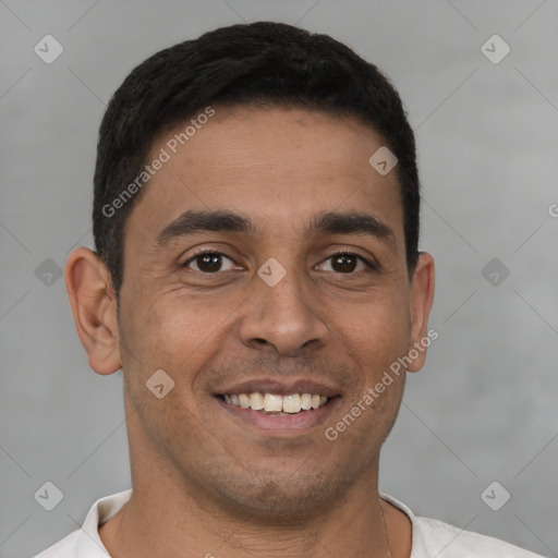 Joyful latino young-adult male with short  brown hair and brown eyes