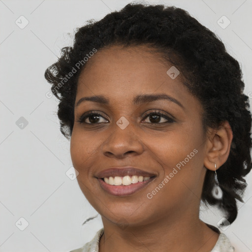 Joyful black young-adult female with long  brown hair and brown eyes