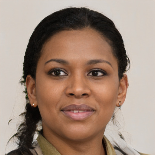 Joyful black young-adult female with medium  brown hair and brown eyes