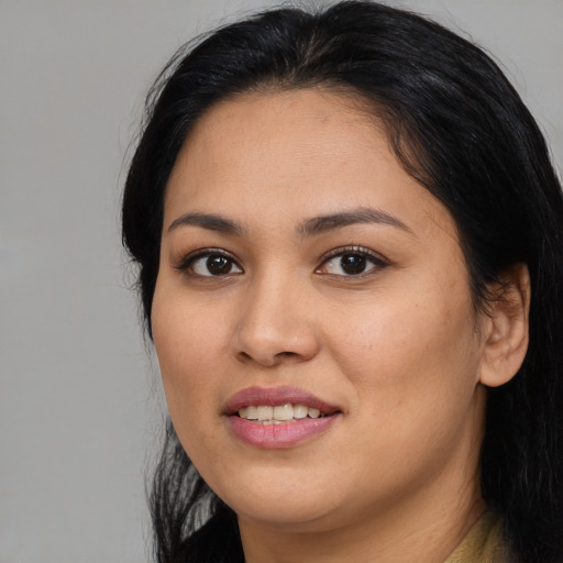 Joyful asian young-adult female with long  black hair and brown eyes