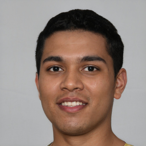 Joyful latino young-adult male with short  black hair and brown eyes