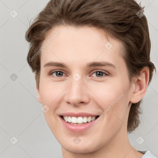 Joyful white young-adult female with short  brown hair and grey eyes