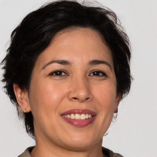 Joyful white adult female with medium  brown hair and brown eyes