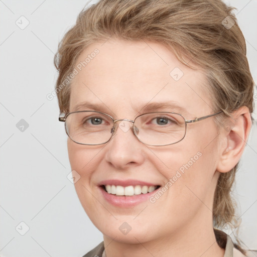 Joyful white adult female with medium  brown hair and blue eyes