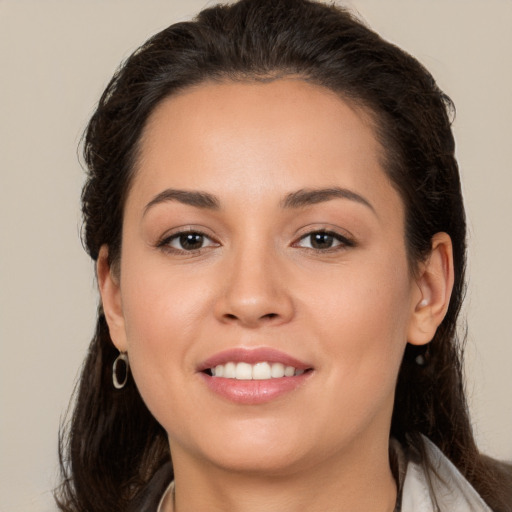 Joyful white young-adult female with long  brown hair and brown eyes