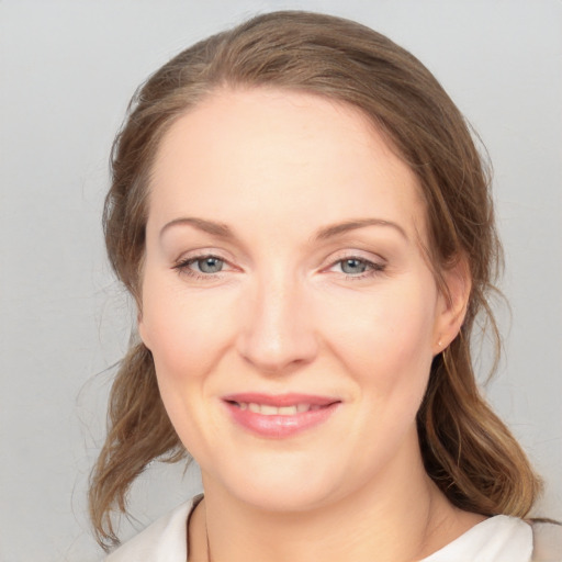 Joyful white young-adult female with medium  brown hair and blue eyes