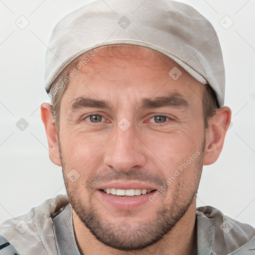 Joyful white adult male with short  brown hair and brown eyes