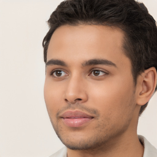 Joyful latino young-adult male with short  brown hair and brown eyes