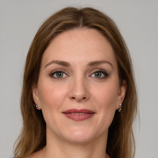 Joyful white young-adult female with long  brown hair and green eyes