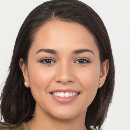 Joyful white young-adult female with long  brown hair and brown eyes