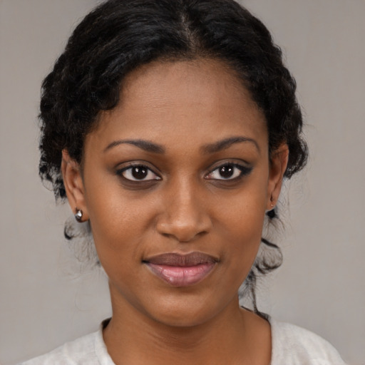 Joyful black young-adult female with medium  black hair and brown eyes