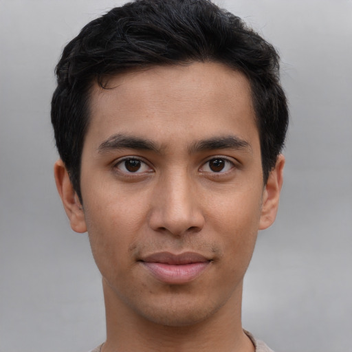 Joyful asian young-adult male with short  brown hair and brown eyes