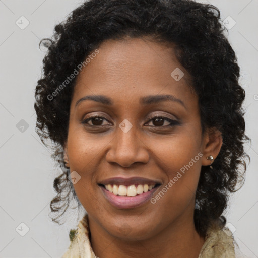 Joyful black young-adult female with long  brown hair and brown eyes