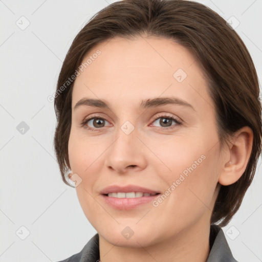 Joyful white young-adult female with medium  brown hair and grey eyes