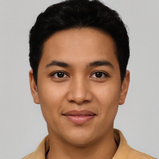 Joyful latino young-adult male with short  black hair and brown eyes