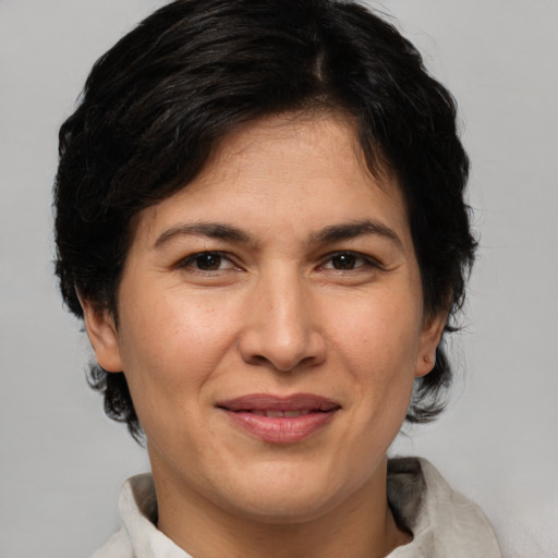 Joyful white adult female with medium  brown hair and brown eyes