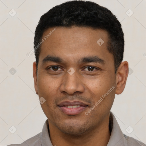 Joyful latino young-adult male with short  black hair and brown eyes