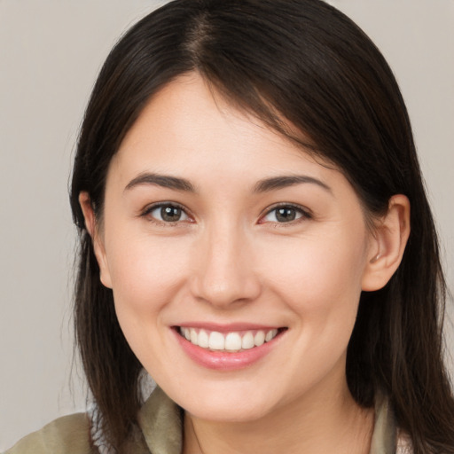 Joyful white young-adult female with medium  brown hair and brown eyes