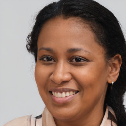 Joyful black young-adult female with long  brown hair and brown eyes