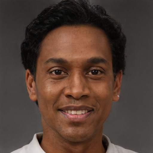 Joyful latino adult male with short  black hair and brown eyes