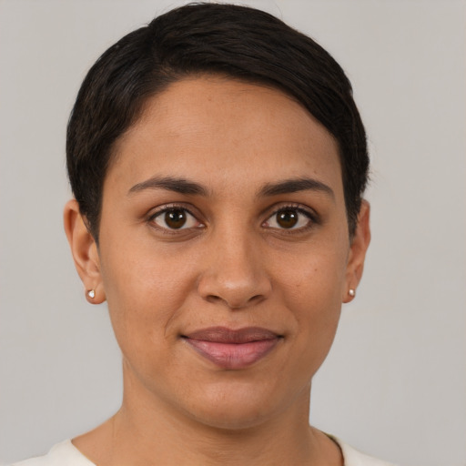 Joyful latino young-adult female with short  brown hair and brown eyes