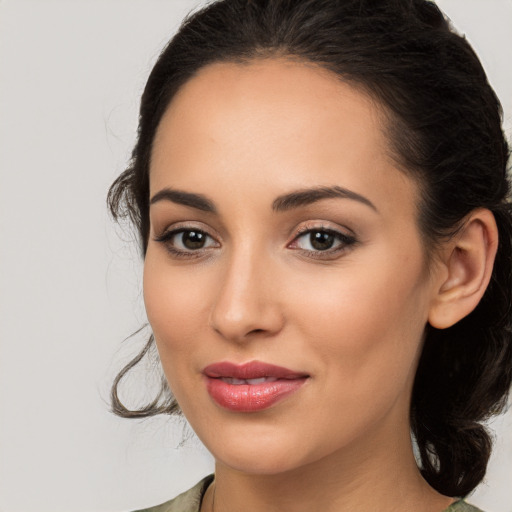 Joyful latino young-adult female with long  brown hair and brown eyes