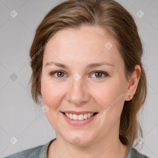 Joyful white young-adult female with medium  brown hair and grey eyes