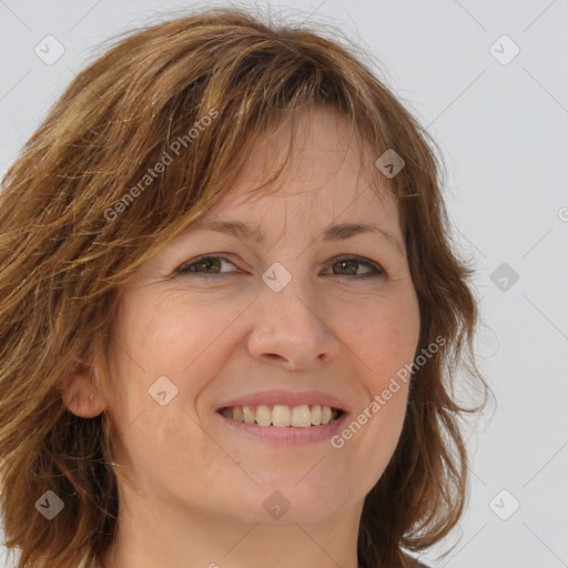 Joyful white adult female with long  brown hair and brown eyes