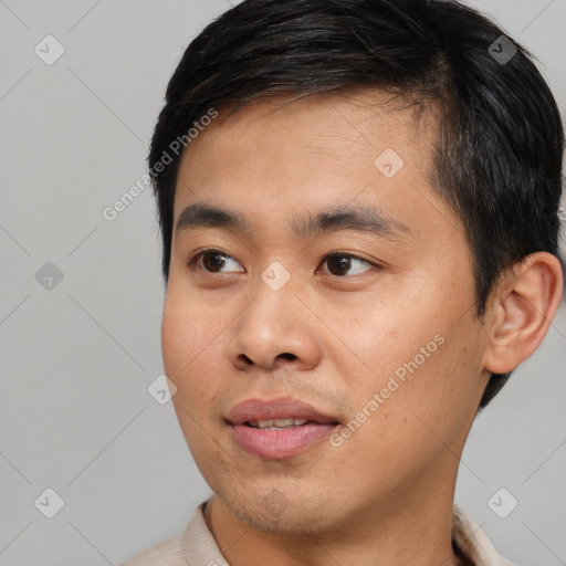 Joyful asian young-adult male with short  black hair and brown eyes