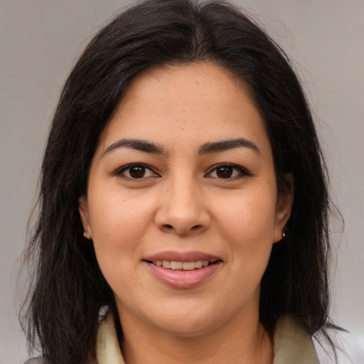 Joyful latino young-adult female with medium  brown hair and brown eyes