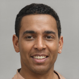 Joyful latino young-adult male with short  brown hair and brown eyes