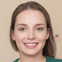 Joyful white young-adult female with medium  brown hair and blue eyes