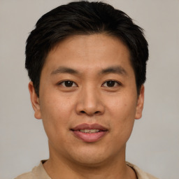 Joyful asian young-adult male with short  brown hair and brown eyes