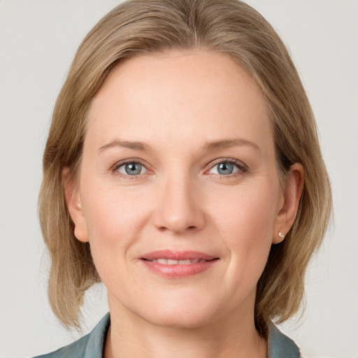 Joyful white young-adult female with medium  brown hair and blue eyes