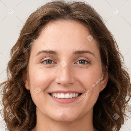 Joyful white young-adult female with long  brown hair and green eyes