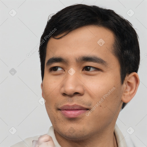 Joyful asian young-adult male with short  black hair and brown eyes