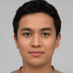 Joyful asian young-adult male with short  black hair and brown eyes