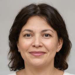 Joyful white adult female with medium  brown hair and brown eyes