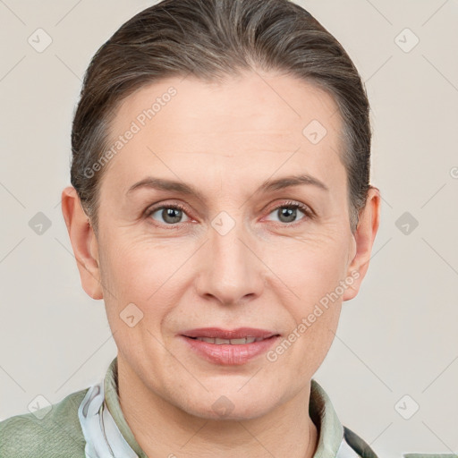 Joyful white adult female with short  brown hair and grey eyes