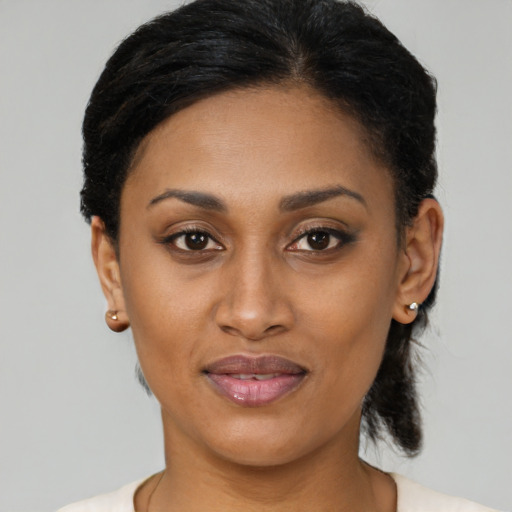 Joyful latino young-adult female with short  black hair and brown eyes