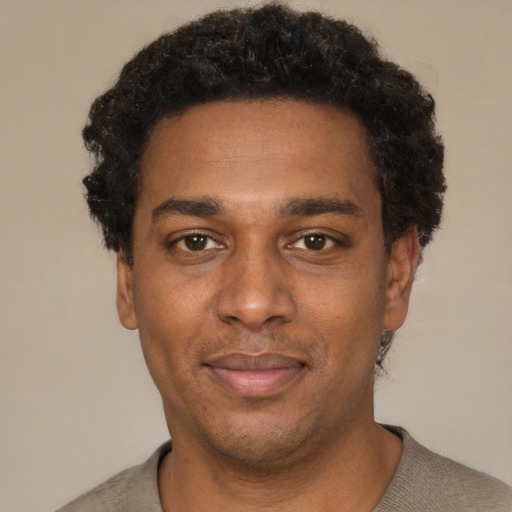 Neutral black adult male with short  black hair and brown eyes