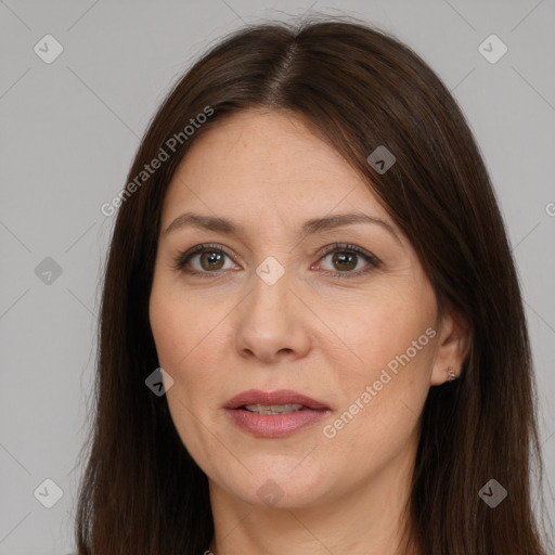 Joyful white adult female with long  brown hair and brown eyes