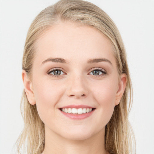 Joyful white young-adult female with long  brown hair and blue eyes