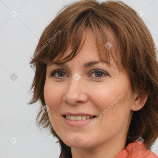 Joyful white adult female with medium  brown hair and brown eyes