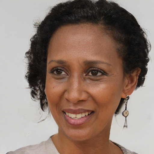 Joyful black adult female with short  brown hair and brown eyes