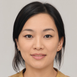 Joyful asian young-adult female with medium  black hair and brown eyes