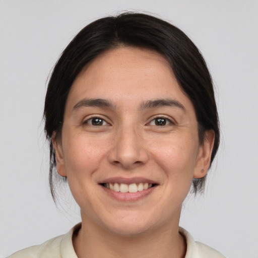 Joyful white young-adult female with medium  brown hair and brown eyes