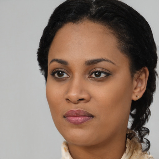 Joyful black young-adult female with medium  black hair and brown eyes