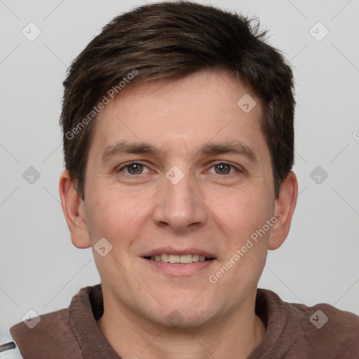 Joyful white adult male with short  brown hair and grey eyes